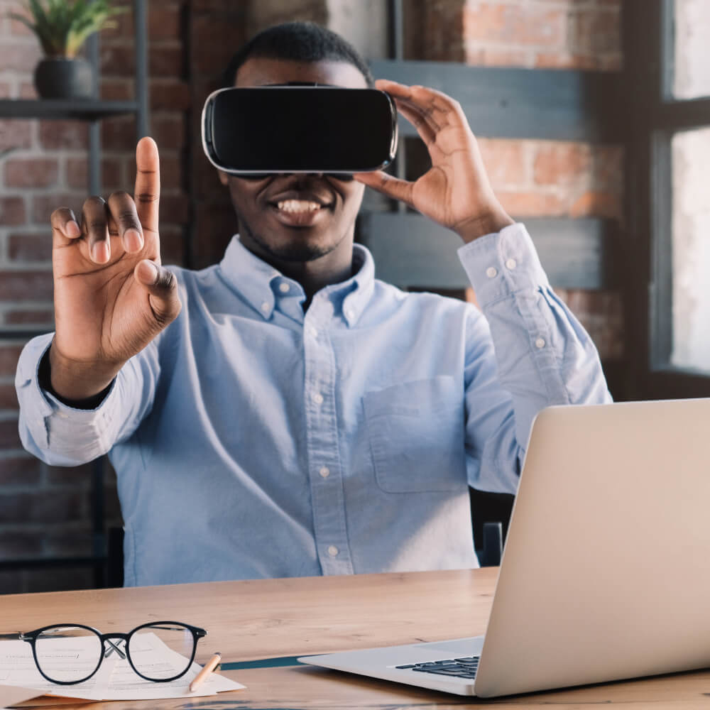 young african businessman in vr headset points fin QSRHLUH 1